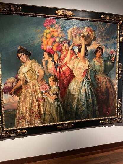 Title: Floreal
Painter: Ignacio Pinazo Camarlench
1915

Allegory of spring with young men and women dressed in regional costumes, carrying fruits and flowers, with vibrant and exuberant colors, evoking the richness and vitality of the season.